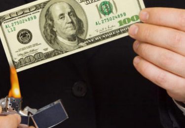 Hands and burnning money - business concept